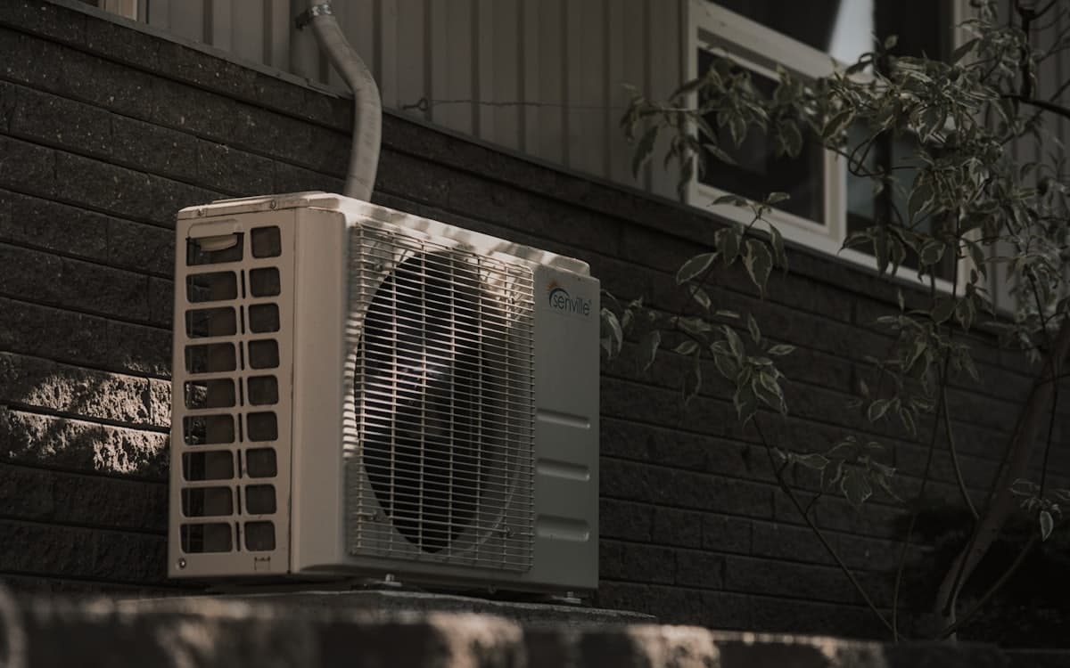 An air-conditioning condenser unit outside a home